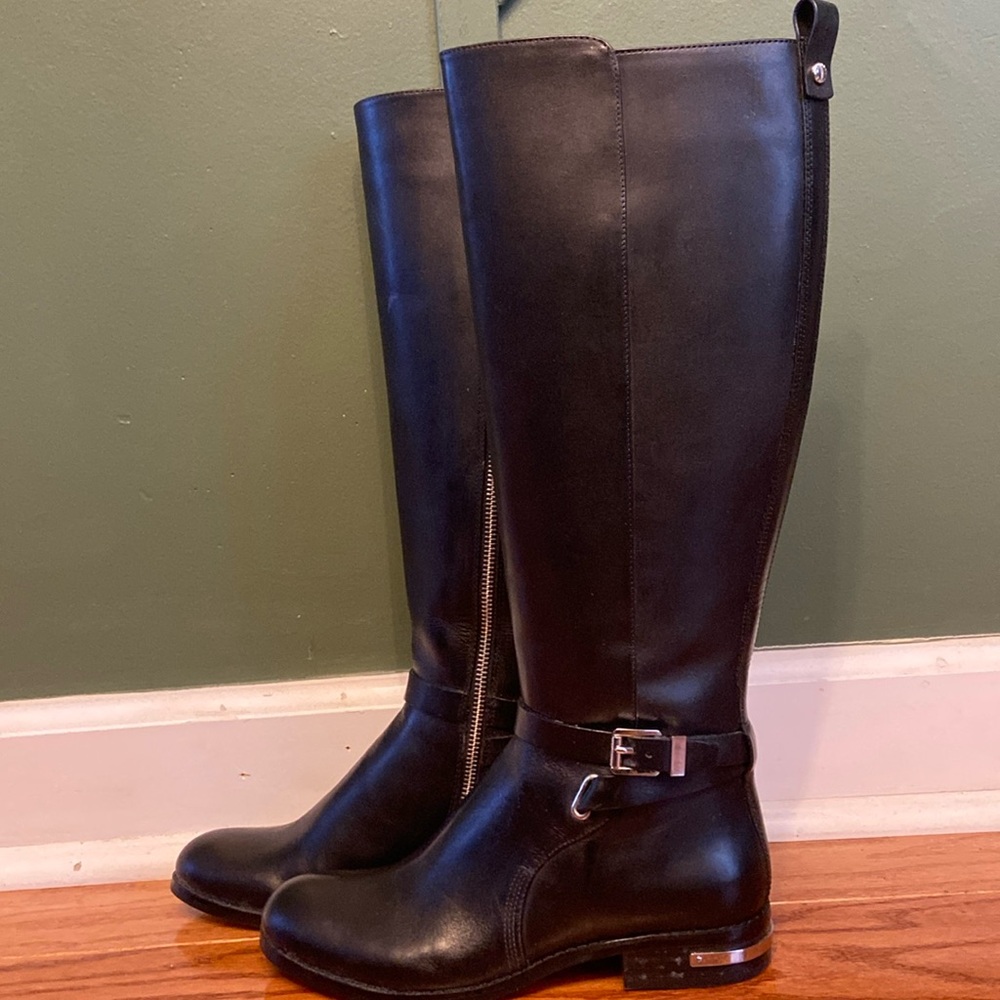 Michael Kors riding boots in the color black.